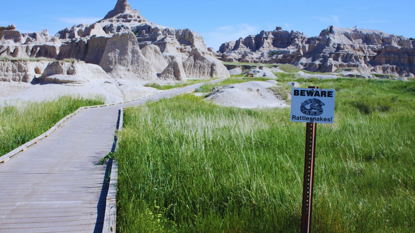  A "danger" sign displayed on a wooden boardwalk warns visitors of potential hazards ahead.