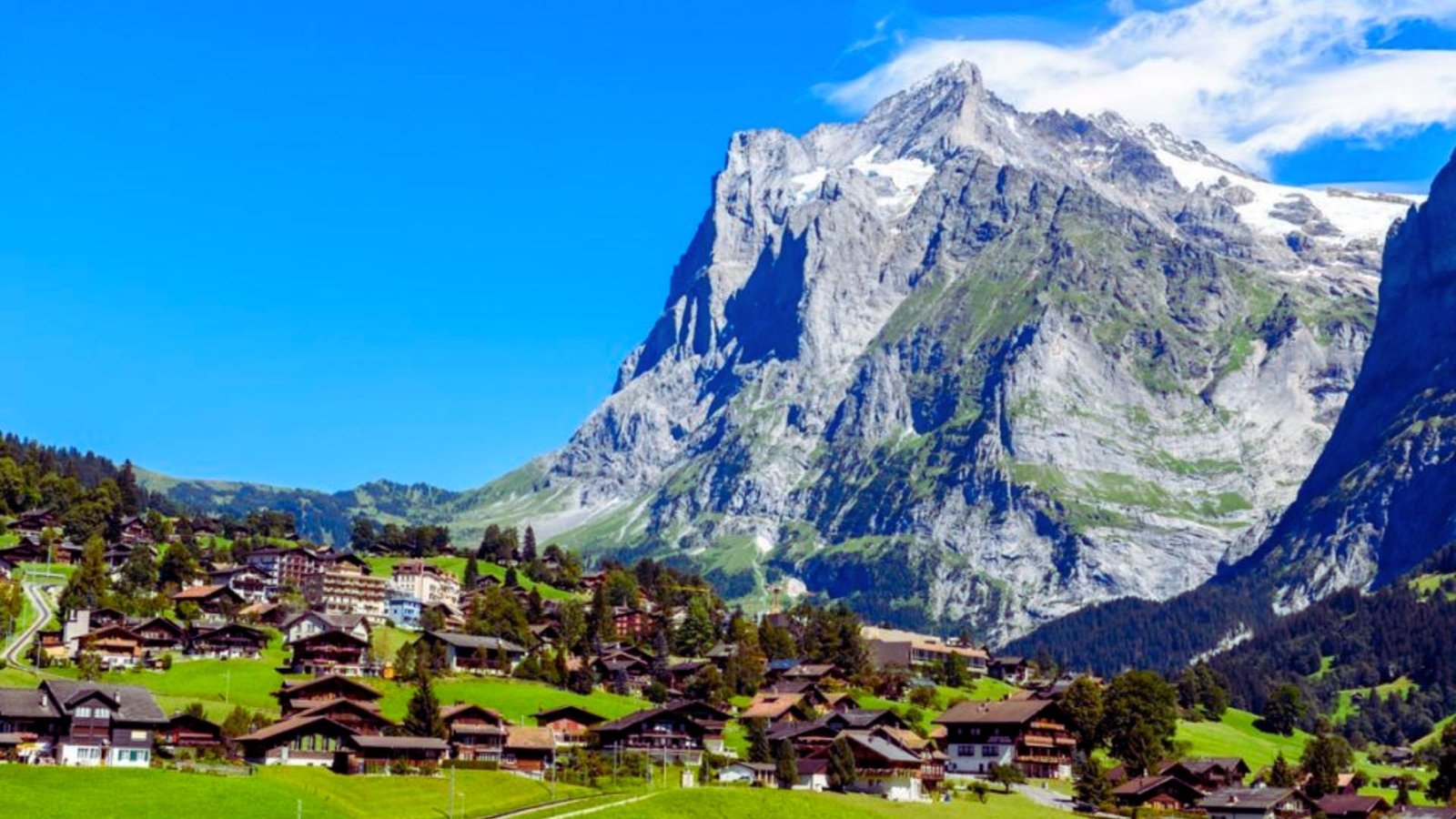  Scenic view of the Swiss Alps, showcasing majestic snow-capped peaks and lush green valleys in Switzerland.