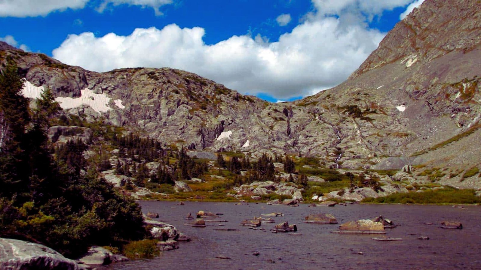 A picturesque lake nestled between towering mountains, showcasing nature's beauty and serene landscape.