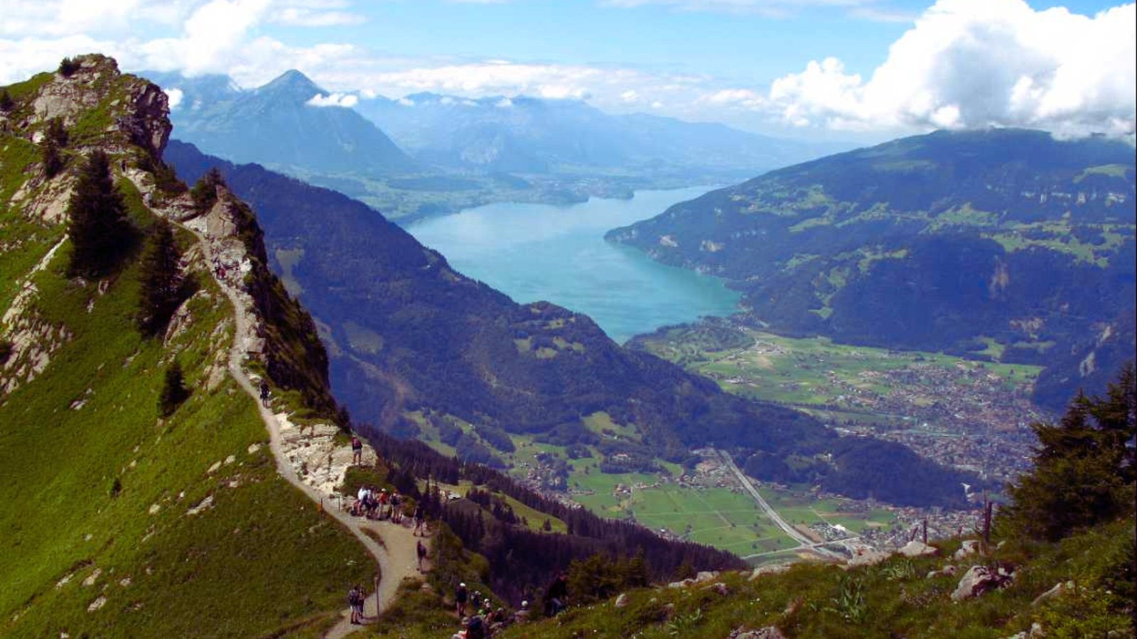  Scenic view of a mountain range reflected in a tranquil lake under a clear blue sky.