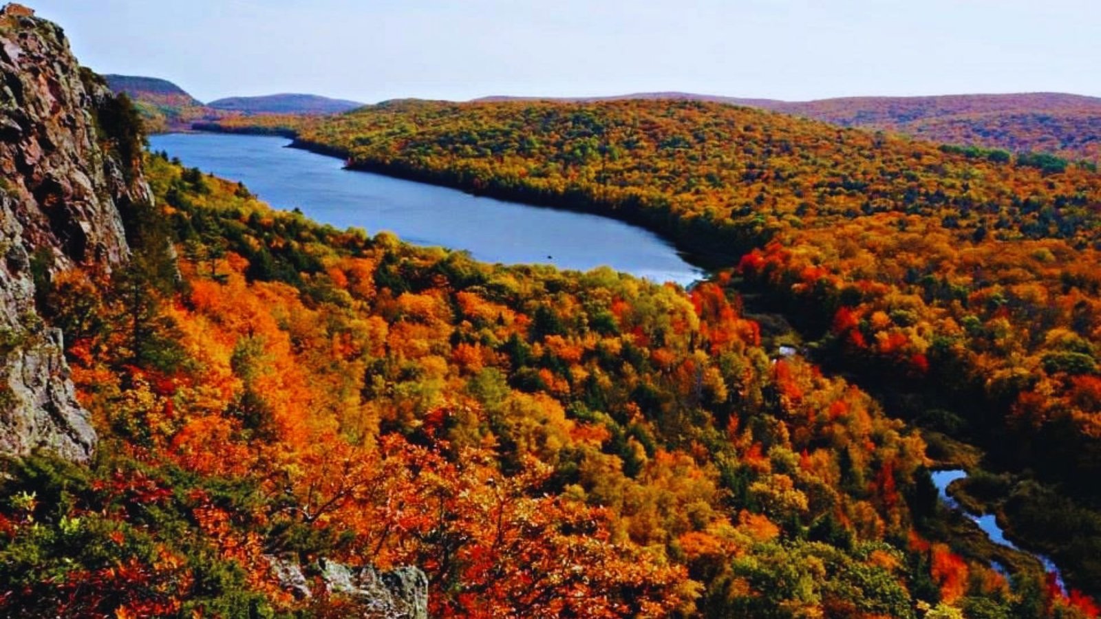 Scenic view of Porcupine Mountains Wilderness State Park in Ontario, showcasing lush forests and rugged mountain terrain.
