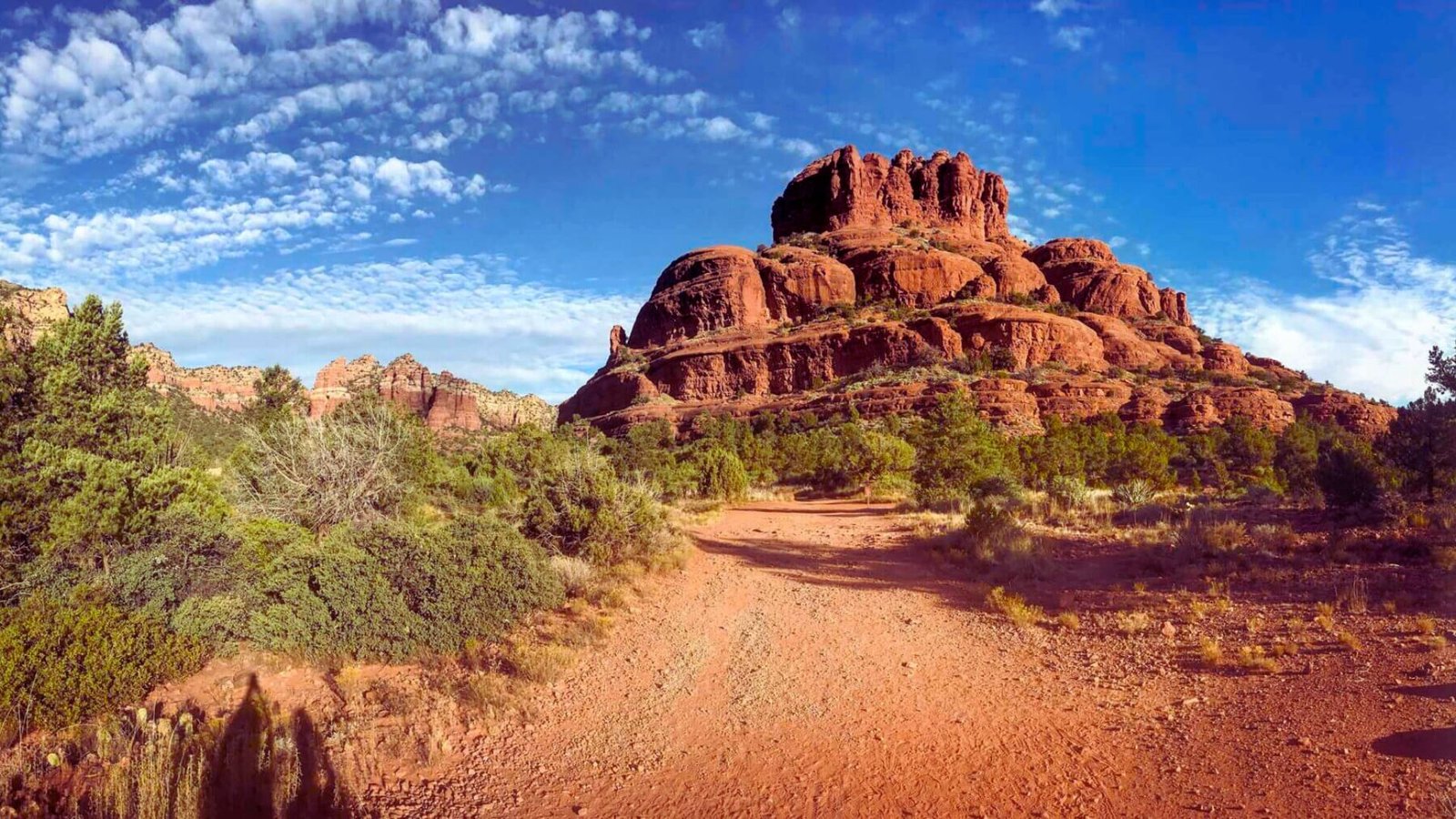 Red rock formations in Sedona, Arizona, showcasing vibrant colors and unique geological shapes against a clear blue sky