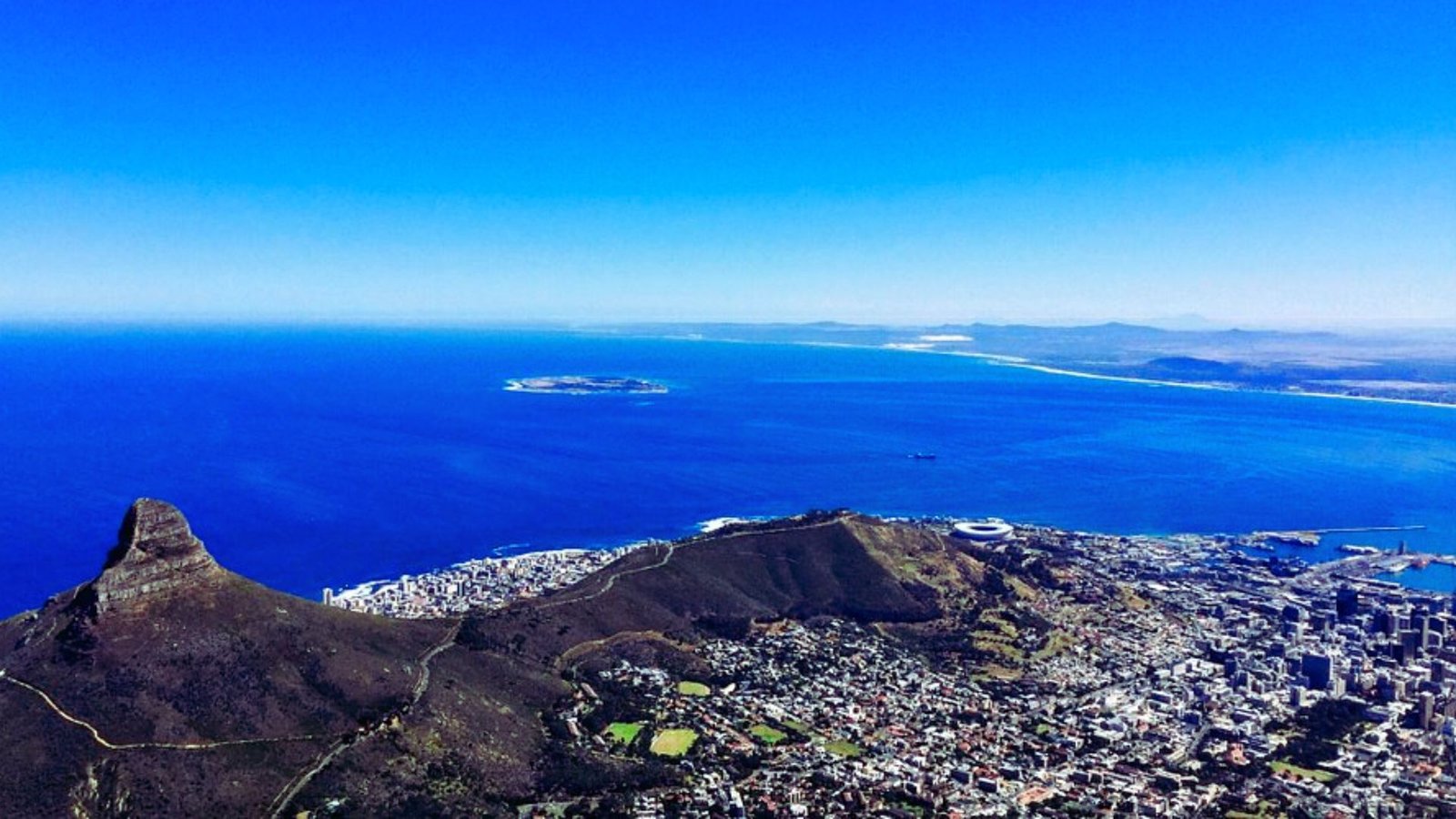 . A panoramic view of Cape Town from the summit of Table Mountain, showcasing the city and coastline below.