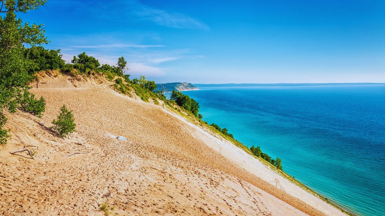 Scenic view of the sandy dunes at Dunes National Seashore in Michigan, showcasing natural beauty and coastal landscape.
