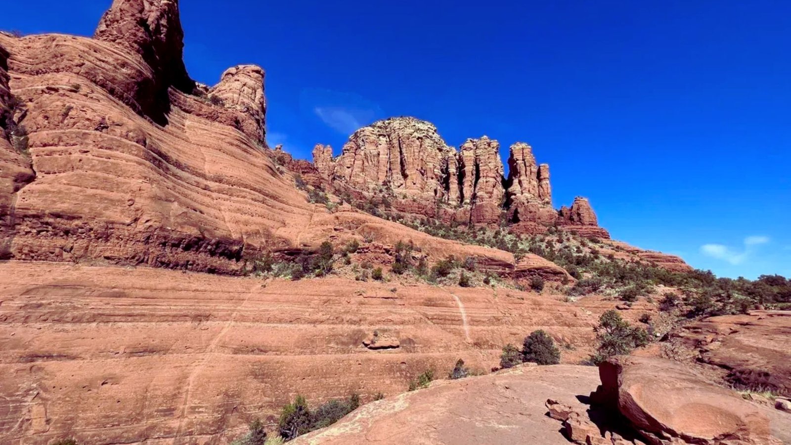 Red rock formations in Sedona, Arizona, showcasing vibrant colors and unique geological shapes against a clear blue sky.